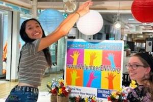 Photo of a volunteer helping set up lanterns