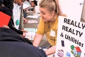 Photo of a volunteer helping students during Reality Check Day 